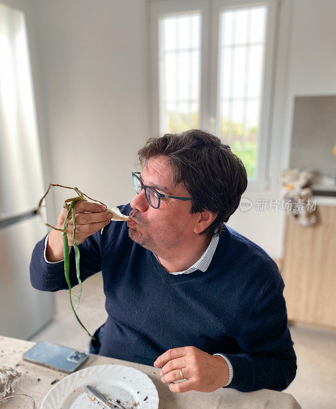 Man eating a ‘calçot’ a type of roasted spring onion or scallion